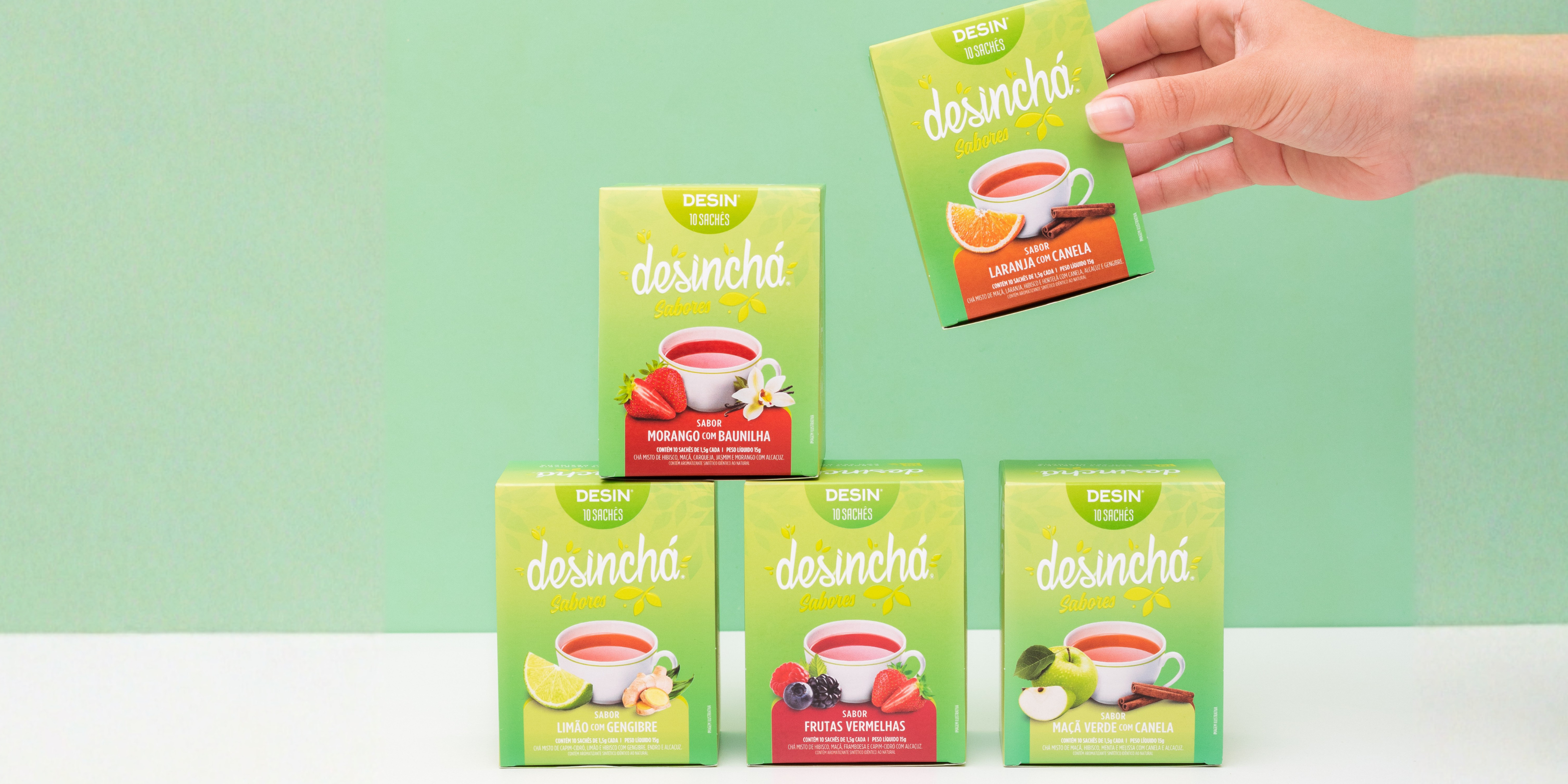Boxes of fruity detox desincha teas carefully set on a white table with green background 