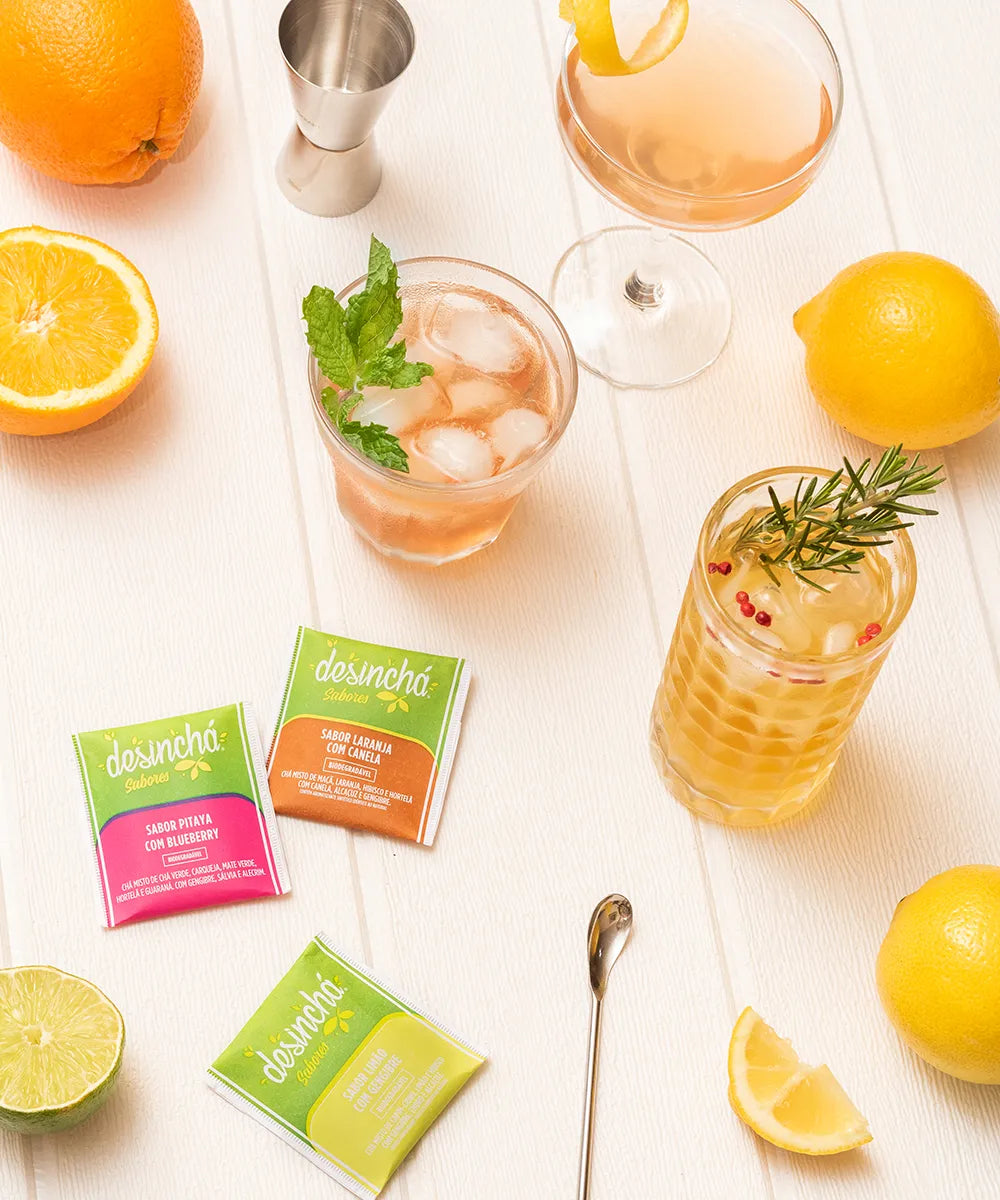 Assorted Desinchá teas with natural ingredients and citrus garnishes, presenting a refreshing arrangement of iced tea beverages for a healthy, flavourful infusion.